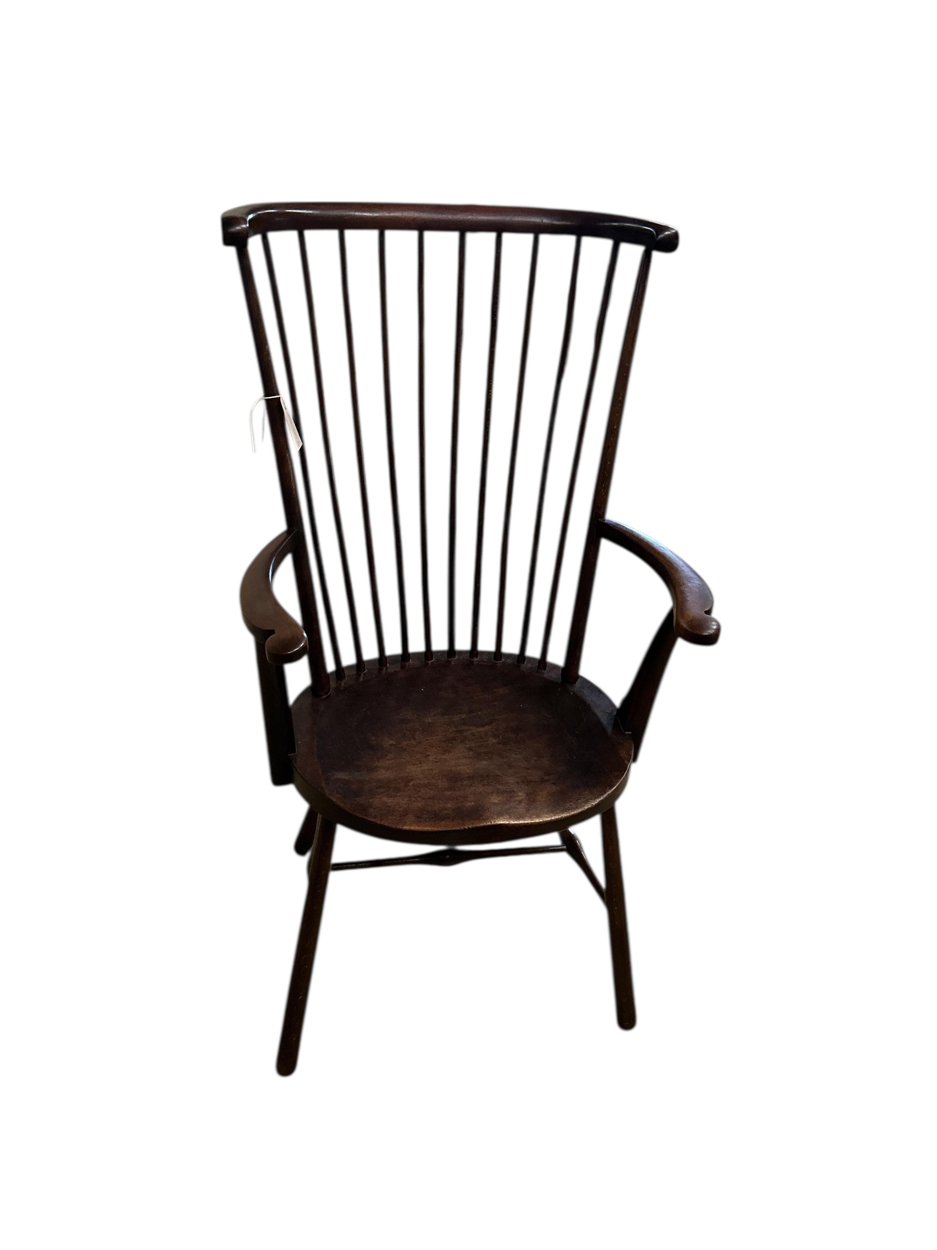 An Arts & Crafts Liberty style Windsor comb back armchair, width 59cm, depth 43cm, height 109cm